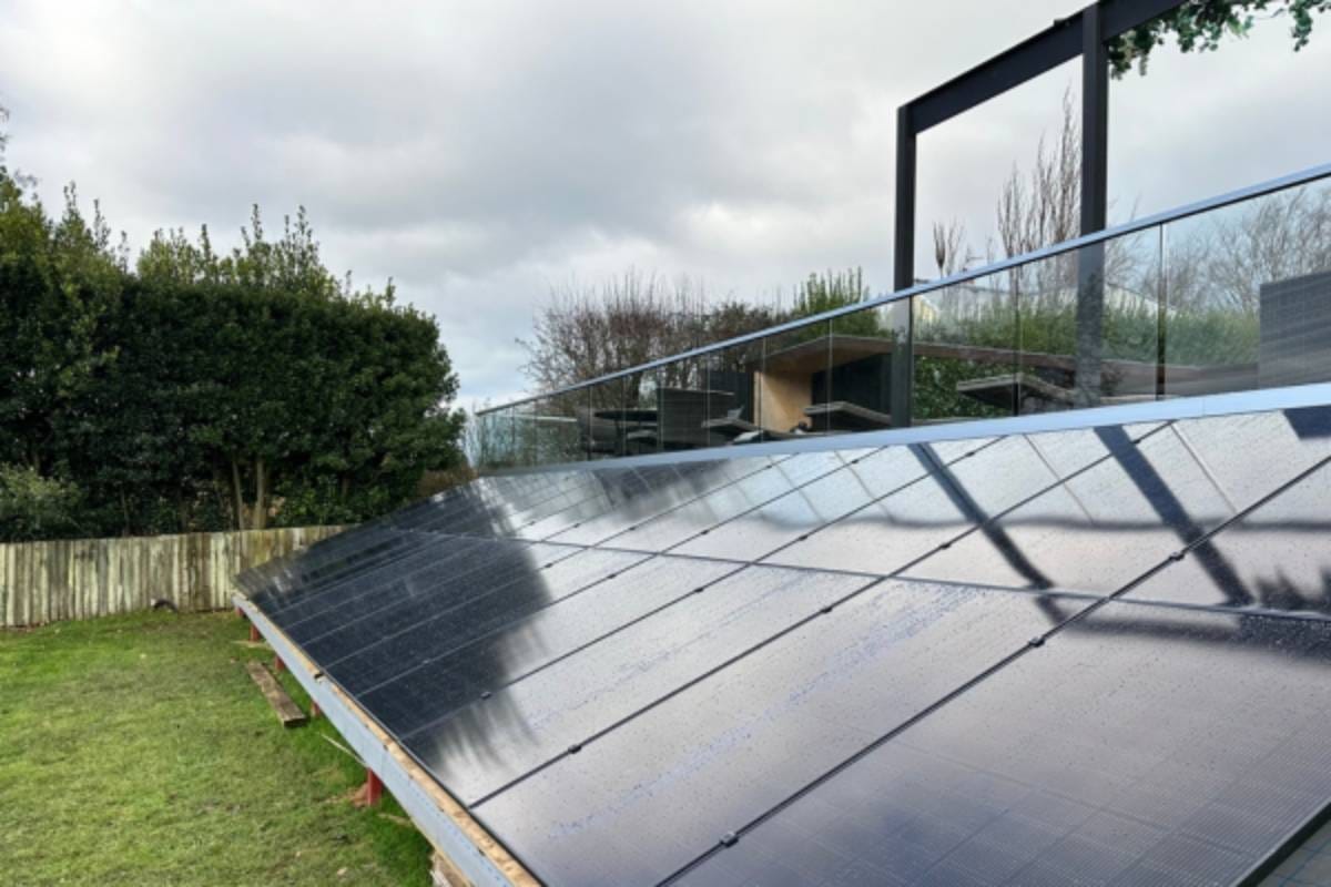 A ground mounted solar panel system below an outdoor seating area.