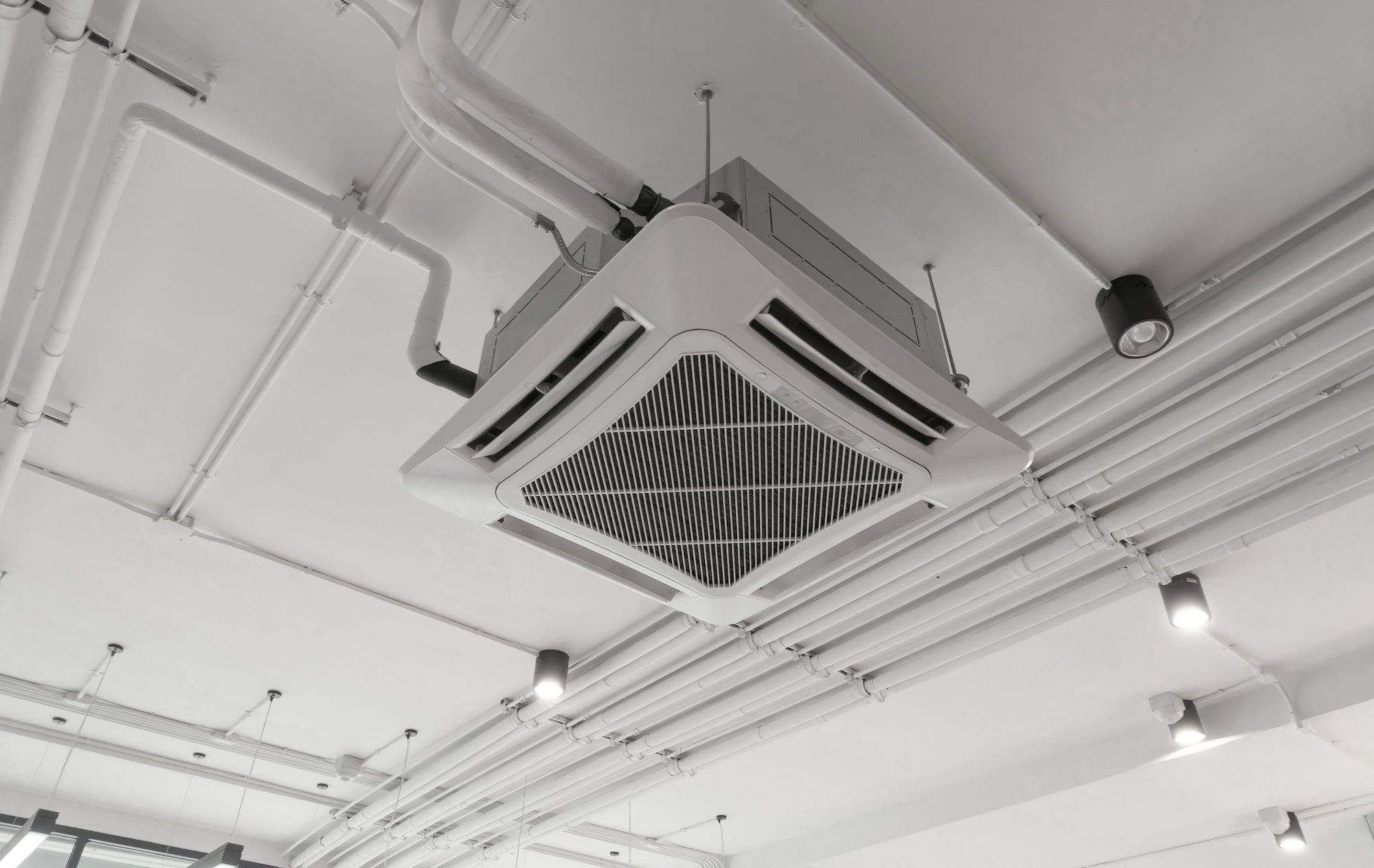 Ceiling mounted cassette type air conditioner in building system work. Ventilation compressor.